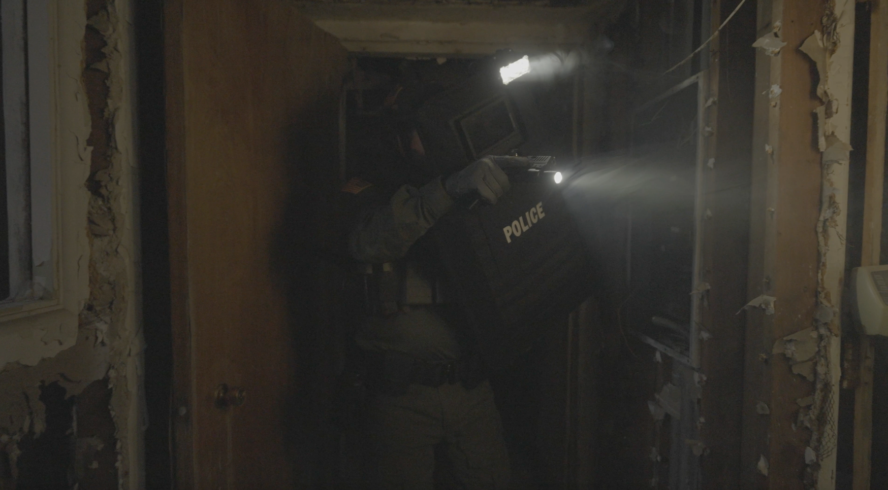Police Officer clearing a room with a ballistic shield and ballistic shield light