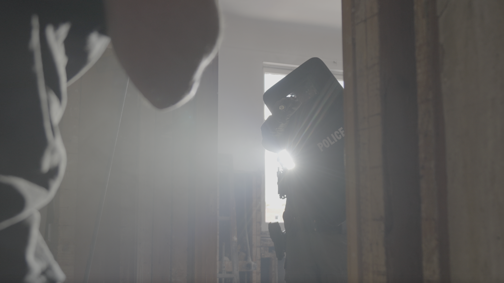 Police Officer using a shield and finding suspect with shield llight